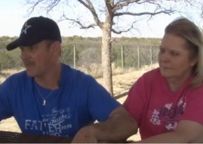 Bradon's parents sitting together at a picnic table