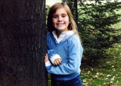 Jeanine Nicarico posing by a tree