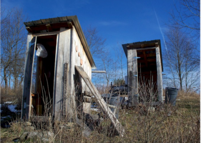 tattered, broken down outhouses