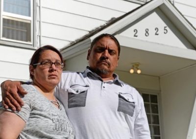 Savanna's parents standing in front of a house