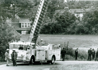 field surrounded by police and fire engine