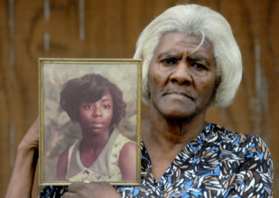 Addie Jones holding photo of her daughter