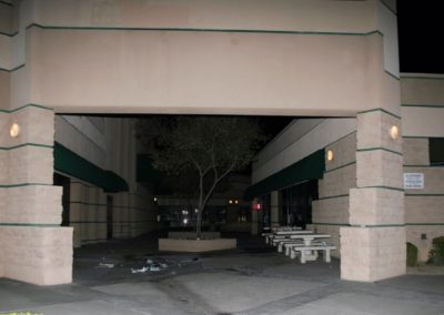 A crime scene photo of the entrance to an open-air breezeway and courtyard next to Subway