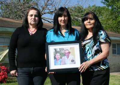 Antonio and Luz’ daughters holding a beloved photo of their parents.