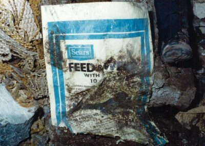 Scraps of a Sears Feed & Weed bag found mixed in with the remains.