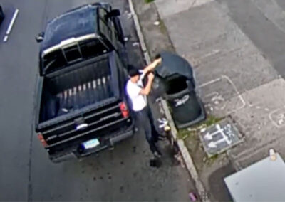 Fotis dumping trash bags.