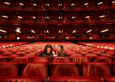 hosts of Crime Junkie in auditorium