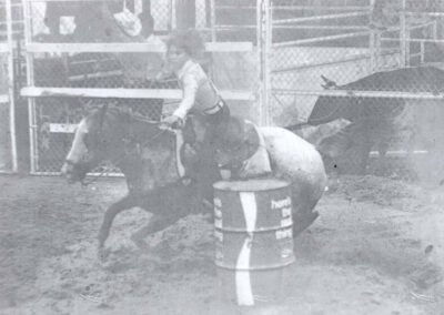 Rowena riding her horse at a rodeo.