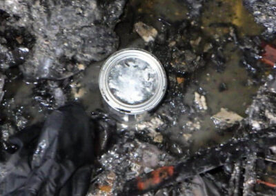 The metal can on the floor by the stove that the Chicago Police Department sent off for testing.
