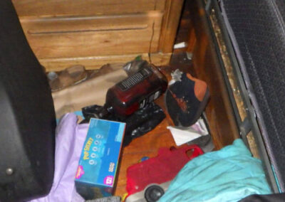 The bottle of Jack Daniel's on the floor by Summer’s bed.