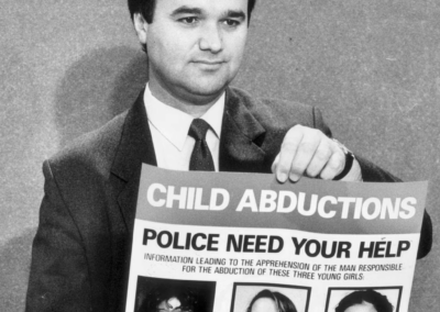 Lead Inspector David Sprague with a reward poster