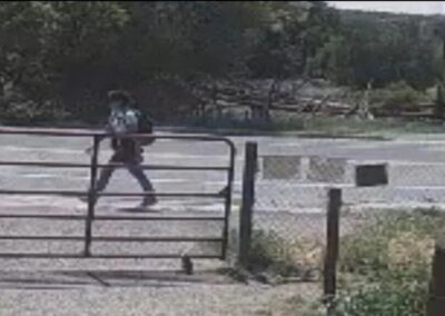 Melissa on surveillance walking along Highway 518.