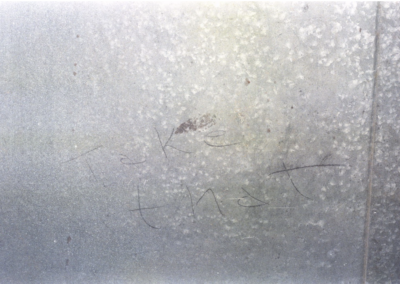 The words “take that” written on Margaret’s garage doors.