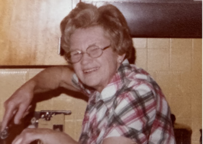Margaret Reimann standing in her kitchen smiling