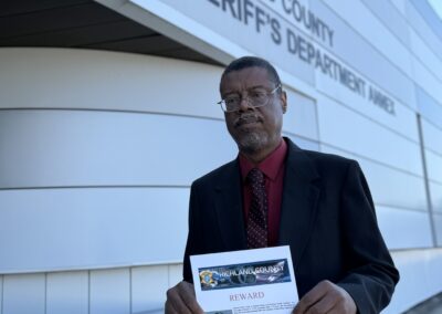 Beatrice’s brother, Cedric Anderson, holding her reward poster.