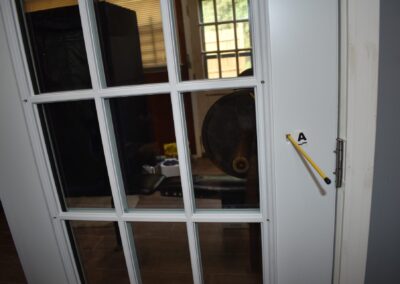 A bullet trajectory through a door frame in the living room, about waist height