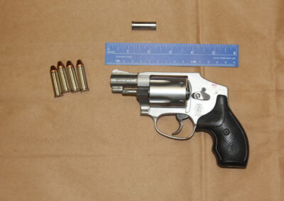 Heather’s revolver, found under a bloody towel beside the toilet, with one spent shell casing still inside.