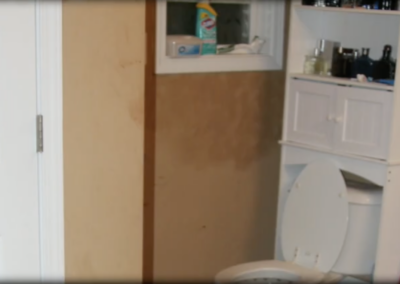 The wall beside the toilet in the bathroom